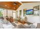 Relaxing screened porch featuring an entertainment area, dining area, and stylish decor at 100 Fountain Springs Rd, Holly Springs, NC 27540