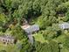 Gorgeous aerial view of the home, nestled among mature trees with an outdoor firepit and storage shed in the back at 1005 Enderbury Dr, Raleigh, NC 27614