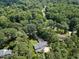 Aerial view showing the property surrounded by beautiful, mature trees at 1005 Enderbury Dr, Raleigh, NC 27614