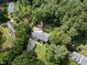 Beautiful aerial view of the property with lush greenery, a fire pit area, and an outbuilding at 1005 Enderbury Dr, Raleigh, NC 27614