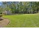 Expansive backyard with a shed, swing set, and well-maintained lawn perfect for outdoor activities at 1005 Enderbury Dr, Raleigh, NC 27614