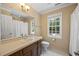 Well-lit bathroom with vanity, window, and neutral color scheme at 1005 Enderbury Dr, Raleigh, NC 27614