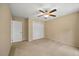 Cozy bedroom featuring neutral walls, plush carpeting, and a ceiling fan at 1005 Enderbury Dr, Raleigh, NC 27614