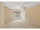 Bright bedroom with a ceiling fan, a large window, and neutral carpeting at 1005 Enderbury Dr, Raleigh, NC 27614