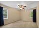Bright bedroom with a ceiling fan, two large windows, and neutral carpeting at 1005 Enderbury Dr, Raleigh, NC 27614
