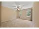 Spacious bedroom with neutral carpeting, a ceiling fan, and bright windows at 1005 Enderbury Dr, Raleigh, NC 27614