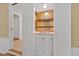 Butler's pantry area with shelves and cabinets with a gold mirrored wall at 1005 Enderbury Dr, Raleigh, NC 27614