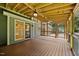 Inviting covered deck with exposed wood ceiling, fan and view of backyard with privacy fence and lawn at 1005 Enderbury Dr, Raleigh, NC 27614