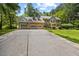 Inviting home with a large driveway, lush lawn, and a welcoming brick facade at 1005 Enderbury Dr, Raleigh, NC 27614