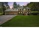 Charming two-story brick home with a three-car garage and landscaped front yard at 1005 Enderbury Dr, Raleigh, NC 27614