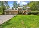 Attractive brick home with a well-manicured lawn and an attached three-car garage at 1005 Enderbury Dr, Raleigh, NC 27614