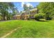Traditional-style home featuring a spacious front yard, brick facade, and three-car garage at 1005 Enderbury Dr, Raleigh, NC 27614