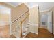 Entryway with hardwood floors, carpeted stairs, and fresh, neutral paint tones at 1005 Enderbury Dr, Raleigh, NC 27614