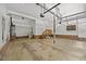 Spacious garage with white walls, ample storage space, and stairs to upper level at 1005 Enderbury Dr, Raleigh, NC 27614