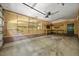 Functional garage with workbench area, brick foundation, and storage shelving at 1005 Enderbury Dr, Raleigh, NC 27614