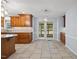 Bright kitchen featuring wood cabinets and drawers plus a door with access to the outside deck at 1005 Enderbury Dr, Raleigh, NC 27614