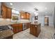 Well-lit kitchen featuring wood cabinets, granite countertops, stainless steel appliances and tile flooring at 1005 Enderbury Dr, Raleigh, NC 27614
