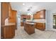 Well-equipped kitchen with stainless steel appliances, tile floors, and a center island at 1005 Enderbury Dr, Raleigh, NC 27614
