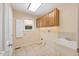 Bright laundry room with cabinets, a sink, and a window providing natural light at 1005 Enderbury Dr, Raleigh, NC 27614