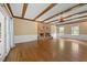 Cozy living room with stone fireplace, wood floors, beamed ceilings, and natural light at 1005 Enderbury Dr, Raleigh, NC 27614