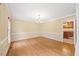 Cozy living room with hardwood floors, a chandelier, and classic trim at 1005 Enderbury Dr, Raleigh, NC 27614