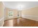 Bright living room featuring hardwood floors, natural lighting, and elegant molding at 1005 Enderbury Dr, Raleigh, NC 27614