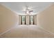 Large main bedroom is complete with neutral walls, plush carpeting, and a ceiling fan at 1005 Enderbury Dr, Raleigh, NC 27614