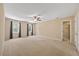 Spacious main bedroom featuring plush carpeting, two windows, and a ceiling fan at 1005 Enderbury Dr, Raleigh, NC 27614