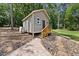 Quaint shed with wooden stairs, complemented by stone accents and surrounded by lush greenery at 1005 Enderbury Dr, Raleigh, NC 27614