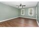 Spacious bedroom with a ceiling fan and two large windows at 1006 Mingo Pl, Knightdale, NC 27545