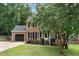 Charming brick two-story home with black shutters, landscaped front yard, and attached garage at 1006 Mingo Pl, Knightdale, NC 27545