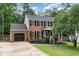 Charming brick two-story home with black shutters, landscaped front yard, and attached garage at 1006 Mingo Pl, Knightdale, NC 27545