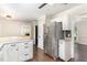 Updated kitchen with stainless steel refrigerator, white cabinets, and breakfast bar at 1006 Mingo Pl, Knightdale, NC 27545