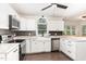 Bright kitchen featuring white cabinets, stainless steel appliances, and dark subway tile backsplash at 1006 Mingo Pl, Knightdale, NC 27545