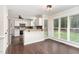 Eat-in kitchen with white cabinets, black backsplash and wood countertop bar at 1006 Mingo Pl, Knightdale, NC 27545