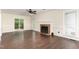 Bright living room features a brick fireplace, wood floors, and access to the back patio at 1006 Mingo Pl, Knightdale, NC 27545
