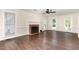 Spacious living room featuring wood floors, a brick fireplace, and ample natural light at 1006 Mingo Pl, Knightdale, NC 27545