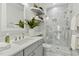 Beautiful bathroom with a modern glass enclosed shower, white cabinets, and floating shelves at 1034 Ventnor Pl, Cary, NC 27519