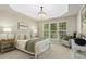 Bright bedroom featuring a tray ceiling, chandelier, large windows and stylish decor at 1034 Ventnor Pl, Cary, NC 27519