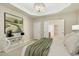 Serene bedroom with stylish decor, an accent painting and an open doorway to the en suite bathroom at 1034 Ventnor Pl, Cary, NC 27519
