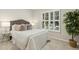 Comfortable bedroom with plush carpeting, a queen-sized bed and a window with plantation shutters at 1034 Ventnor Pl, Cary, NC 27519