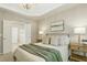 Relaxing bedroom with comfortable bedding, a tray ceiling, and a doorway to the bathroom at 1034 Ventnor Pl, Cary, NC 27519