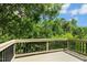 Wood deck with black railings and tree views at 1034 Ventnor Pl, Cary, NC 27519