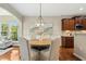 Dining room with hardwood floors, chandelier, and adjacent kitchen and living spaces at 1034 Ventnor Pl, Cary, NC 27519