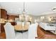 Open concept dining room with chandelier with view to the kitchen and living room at 1034 Ventnor Pl, Cary, NC 27519
