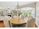 Dining room with a chandelier with seating for six and view to the living room and sunroom at 1034 Ventnor Pl, Cary, NC 27519