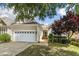 Charming home exterior featuring a two-car garage and well-maintained landscaping at 1034 Ventnor Pl, Cary, NC 27519