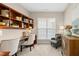 Comfortable home office with built-in shelving, stylish decor and plenty of natural light from the window at 1034 Ventnor Pl, Cary, NC 27519