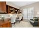A cozy home office with built-in shelves, a large window for natural light and comfortable seating at 1034 Ventnor Pl, Cary, NC 27519