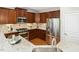 Kitchen with stainless steel appliances, granite countertops, and rich wooden cabinets at 1034 Ventnor Pl, Cary, NC 27519